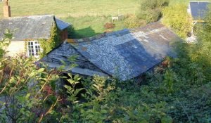 Barn roof showing ground level excavation needed for garden